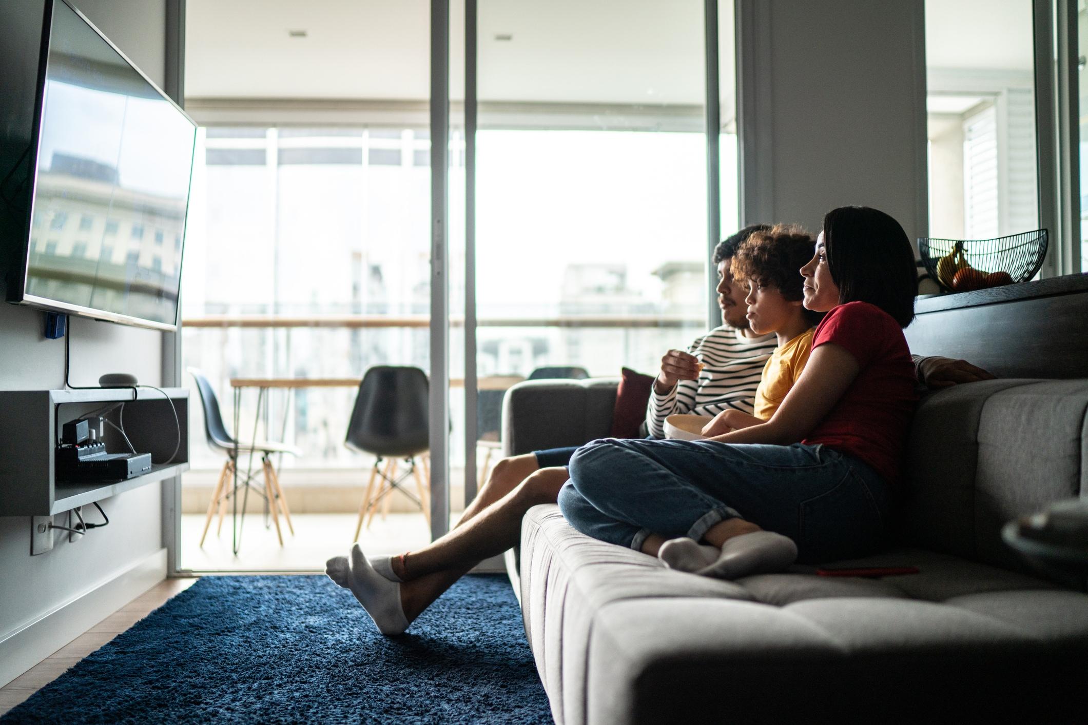Family watching TV at home